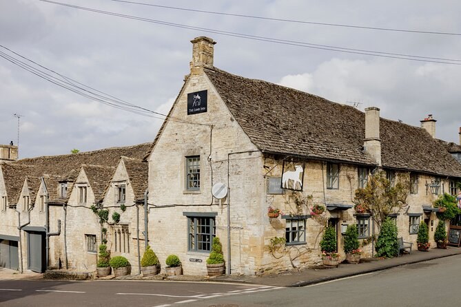 A Cotswold cottage of honey-coloured stone under a stone-tiled roof