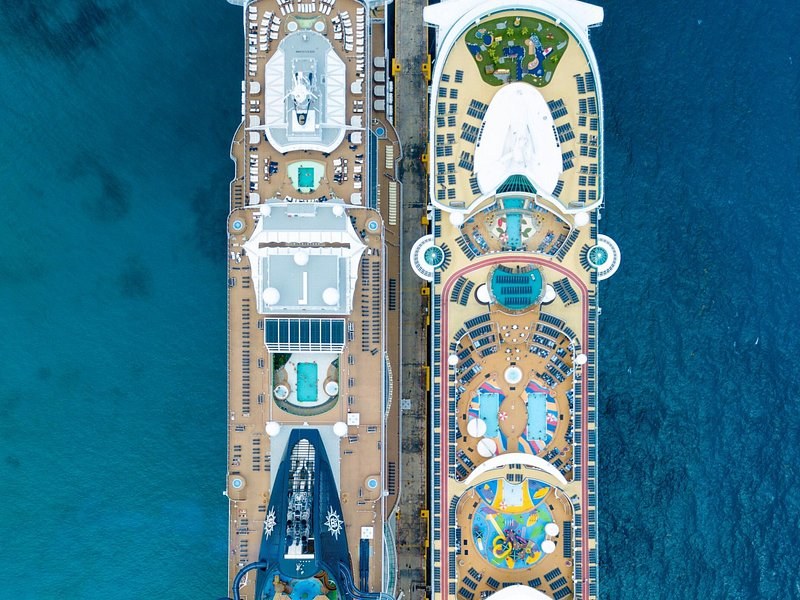 The upper decks and pools of a cruise ship seen from directly overhead