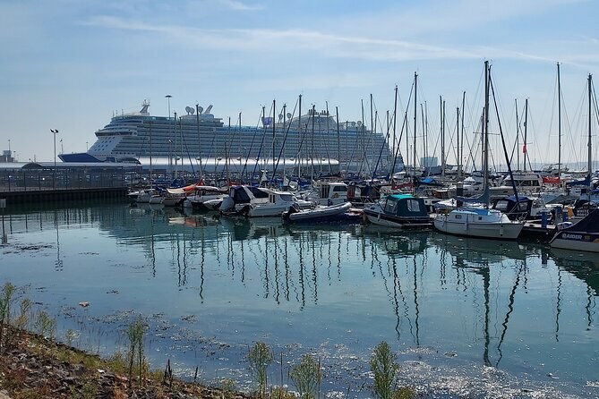 A cruise ship rising above the masts of a marina on Southampton Water