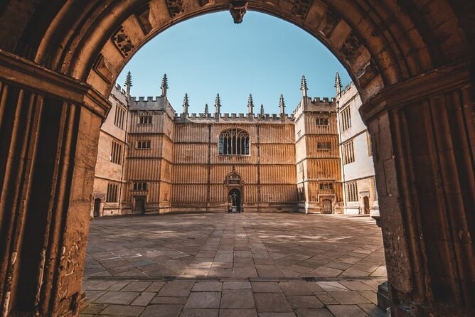 The Bodleian Library quadrangle in Oxford seen through a stone archway