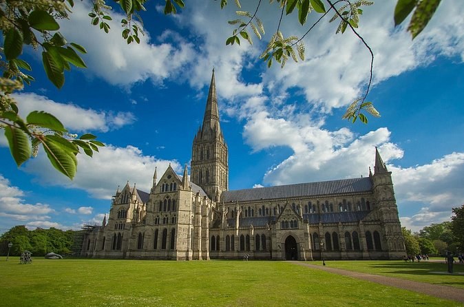 The spire of Salisbury Cathedral framed by trees from the cathedral close